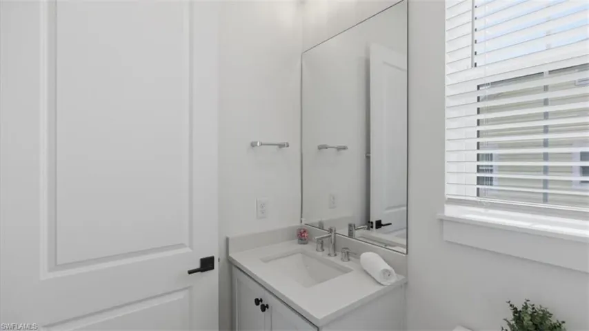 Half bath with vanity and toilet - Virtually Edited