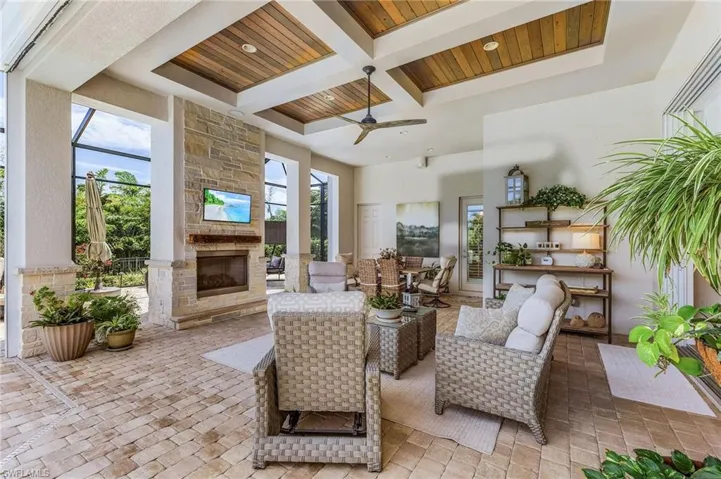 View of patio featuring an outdoor living space with a fireplace and ceiling fan