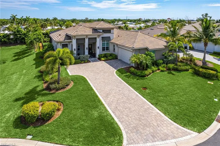 View of front of property featuring a garage and a front yard