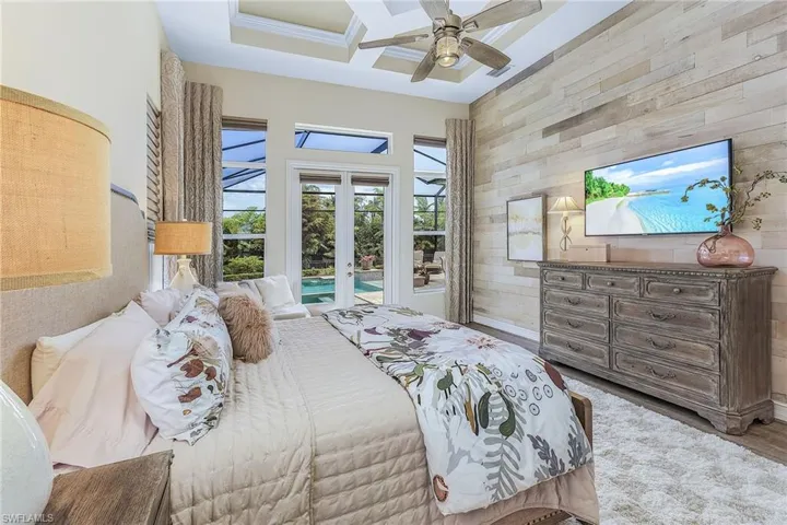 Bedroom featuring ceiling fan, french doors, coffered ceiling, access to exterior, and hardwood / wood-style flooring