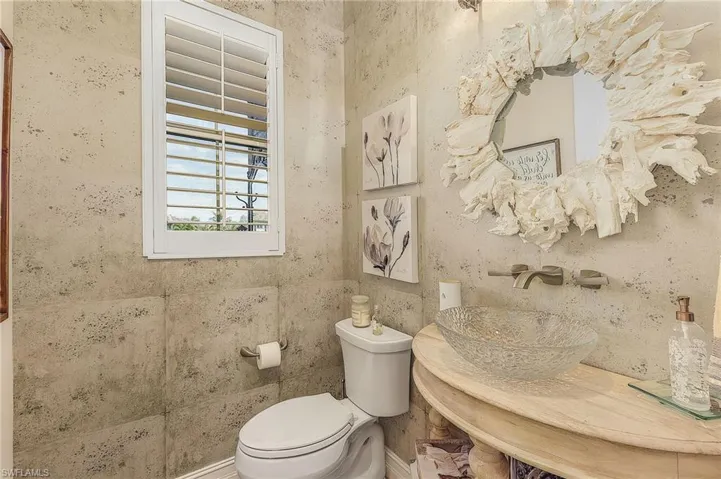 Bathroom featuring tile walls and toilet