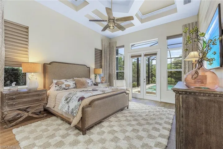Bedroom featuring access to outside, coffered ceiling, wood-type flooring, and ceiling fan