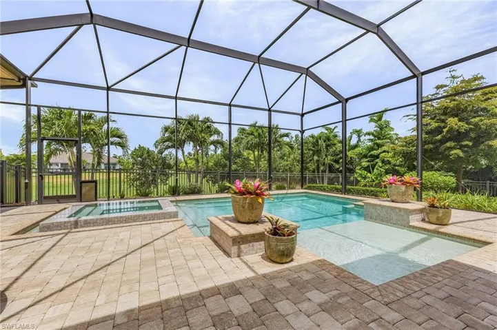 View of pool with a lanai, an in ground hot tub, and a patio