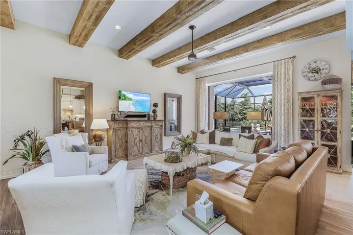 Living room with beam ceiling and light hardwood / wood-style flooring