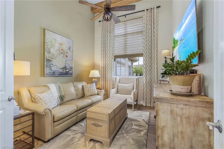 Living room with hardwood / wood-style floors and ceiling fan