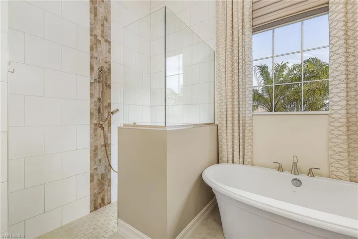 Bathroom featuring separate shower and tub and tile floors