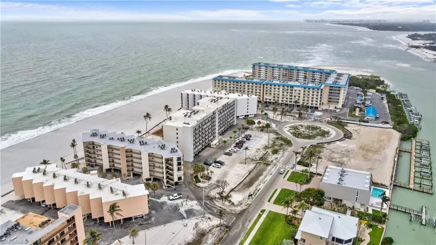 Aerial view featuring a city view, a beach view, and a water view
