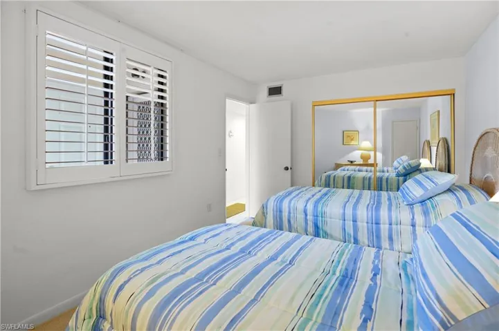 Bedroom featuring carpet, visible vents, a closet, and baseboards