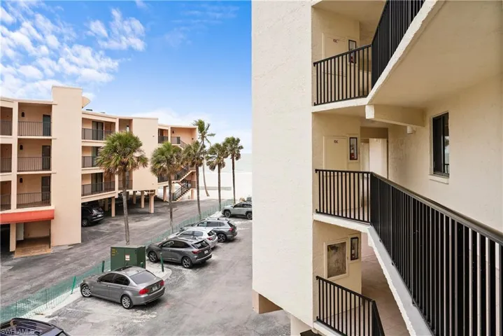 View of property with uncovered parking
