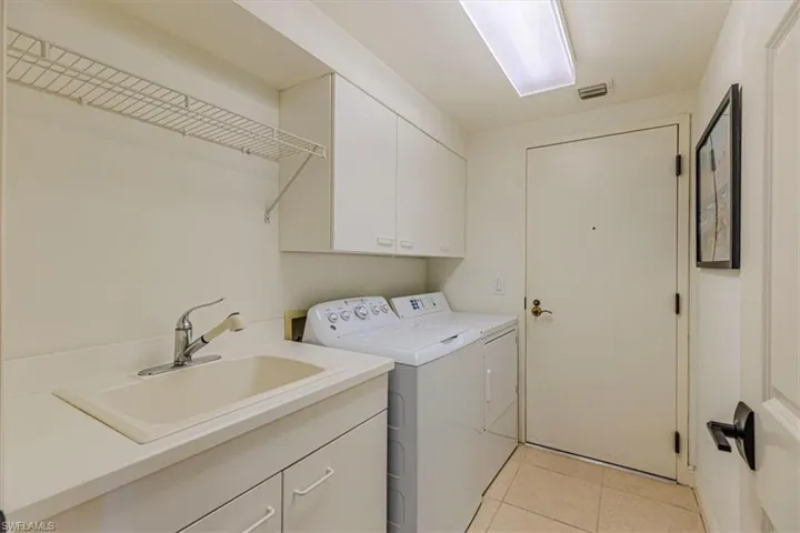 Laundry room with slop sink and extra cabinetry