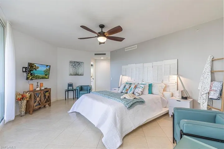 Master Bedroom suite with tile floors & ceiling fan