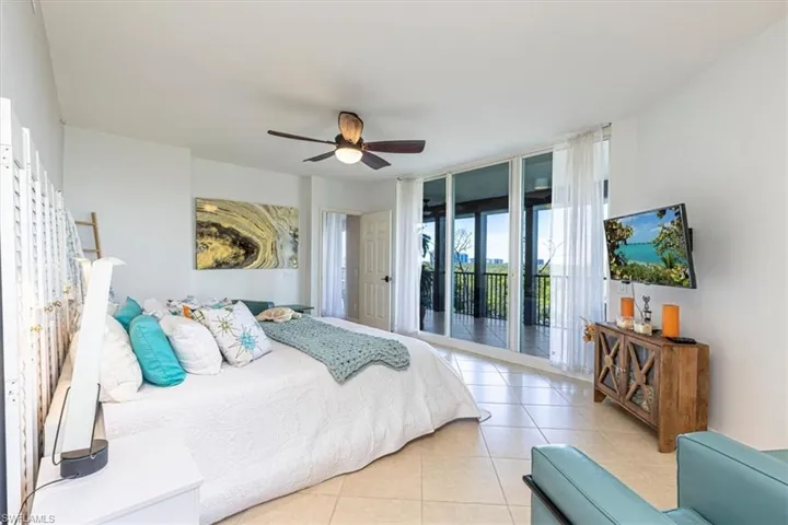 Master Bedroom suite with tile floors, ceiling fan, and lanai access