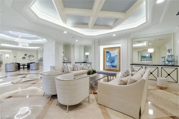 Building lobby with ornamental molding, coffered ceiling, recessed lighting, and beam ceiling