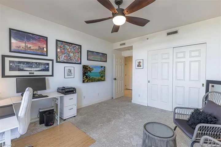 Guest Bedroom / Office or flex room.  New carpet and ceiling fan with balcony access