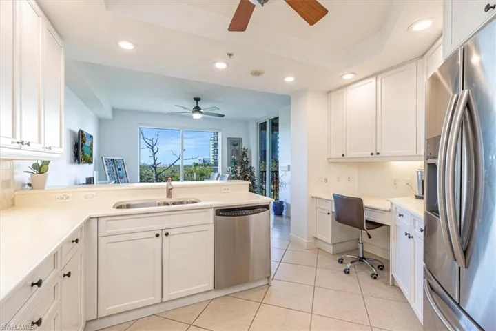 Kitchen featuring white cabinets and countertops, with lots of storage