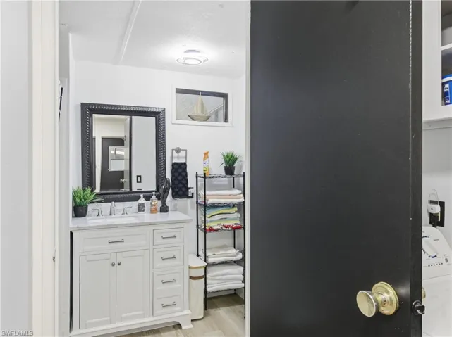 Bathroom with vanity and light wood-style flooring