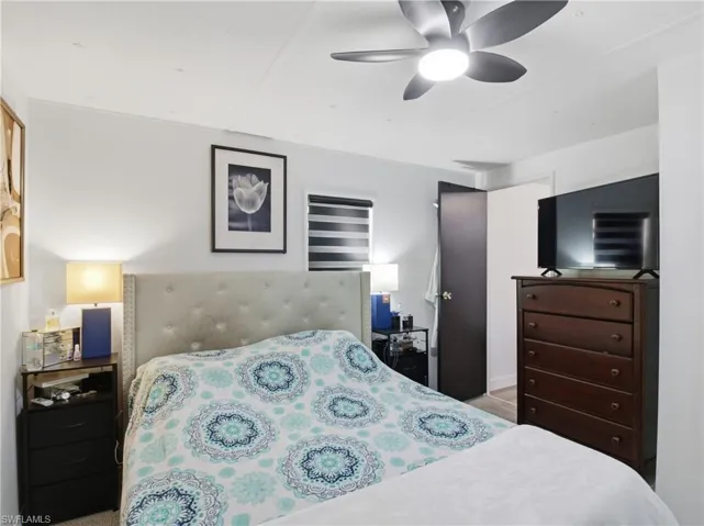 Bedroom featuring a ceiling fan and light carpet
