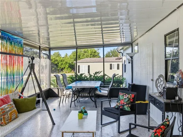 Sunroom / solarium featuring outdoor dining area, plenty of natural light, and an outdoor living space