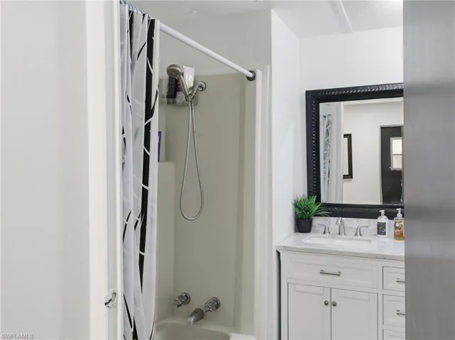 Full bath with vanity and shower / bathtub combination with curtain