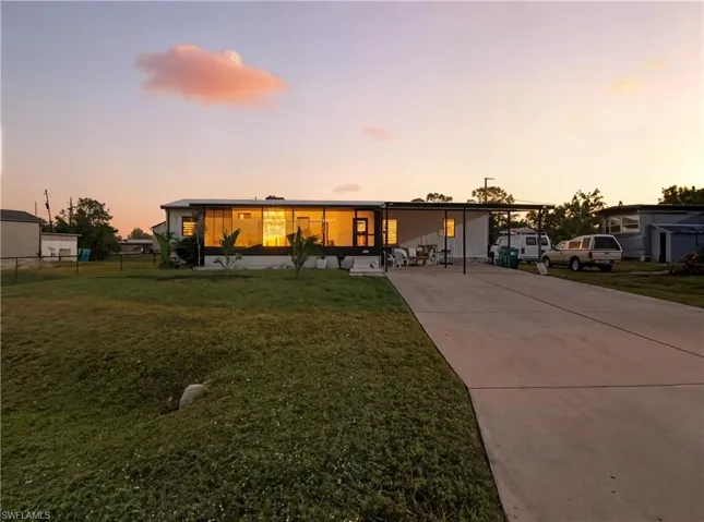 Mid-century inspired home featuring driveway and a front yard
