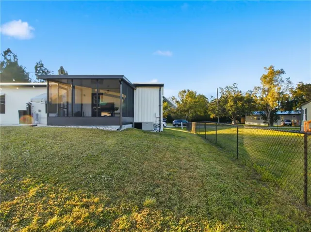 Rear view of house featuring a sunroom