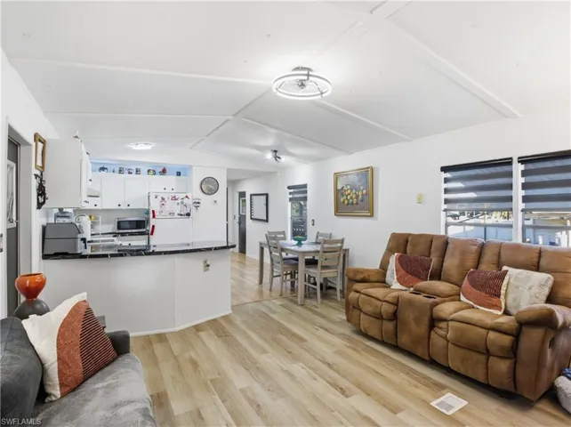 Living area with plenty of natural light and light wood finished floors