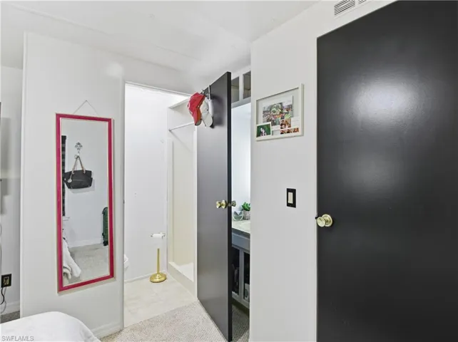 Hallway with light tile patterned flooring