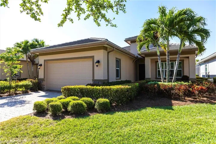 Stucco exterior with a tiled roof and integrated garage