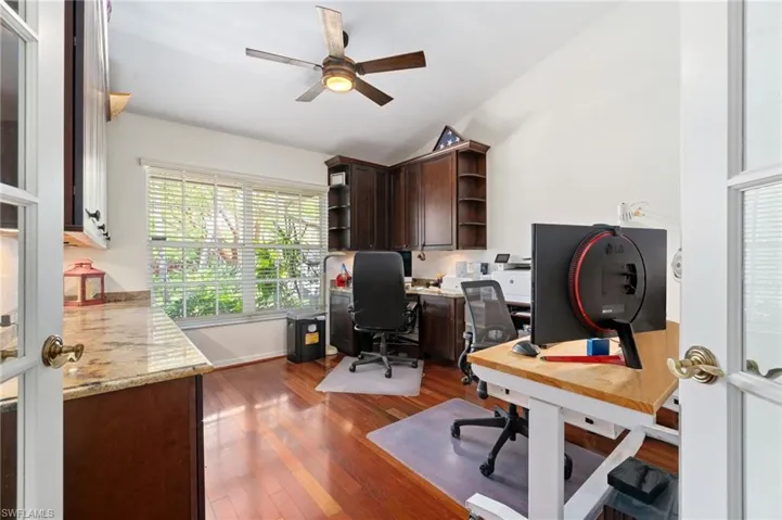 Spacious den/office space with built-in desk and abundant storage area.