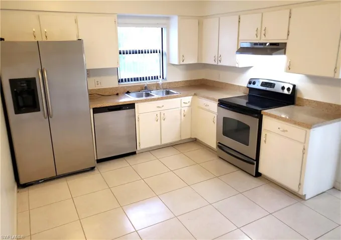 Kitchen with Stainless Appliances and Hood