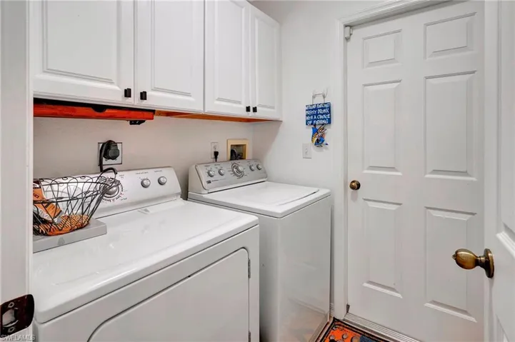 Washroom with independent washer and dryer and cabinets