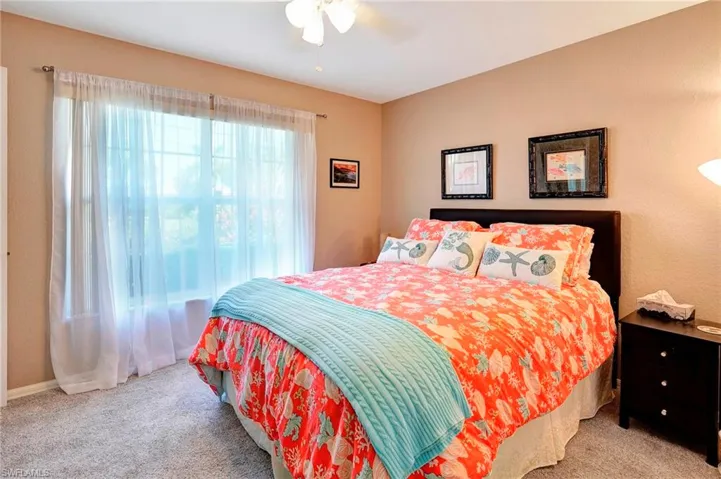 Bedroom featuring ceiling fan and light carpet