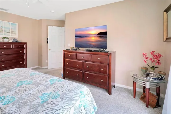 Carpeted bedroom with ceiling fan
