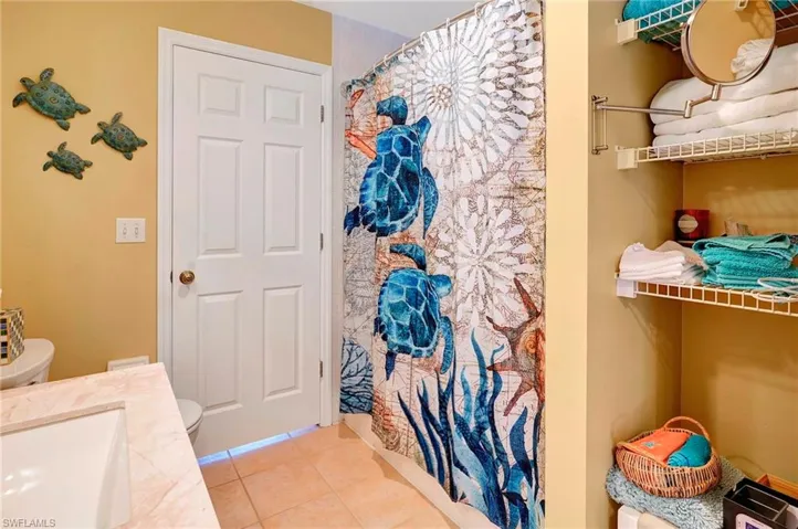 Bathroom with sink, tile patterned flooring, and toilet