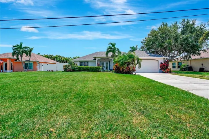 Single story home featuring a front lawn and a garage