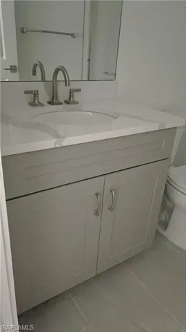 Guest bathroom with quartz countertops and soft-close cabinets
