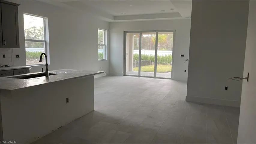 Open-concept floor plan casual dining tucked in on the right, great room, and kitchen from foyer entrance