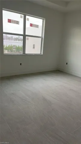 Primary bedroom with tray ceiling (back of house)