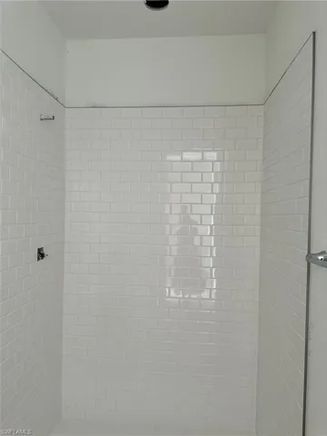 Luxe, walk-in shower in primary bathroom with beautiful shower floor and wall tile