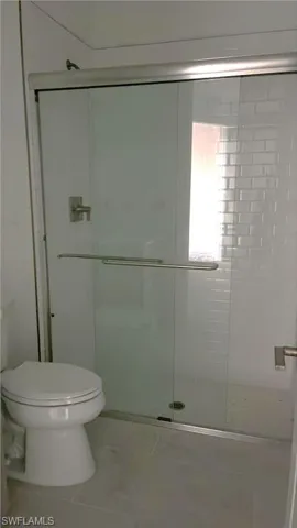 Guest bathroom with walk-in shower, beautiful shower floor and wall tile, and comfort height toilet