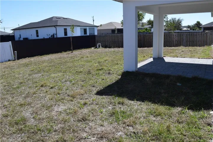 Fenced backyard with a patio