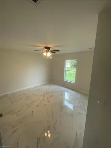 Spare room with ceiling fan