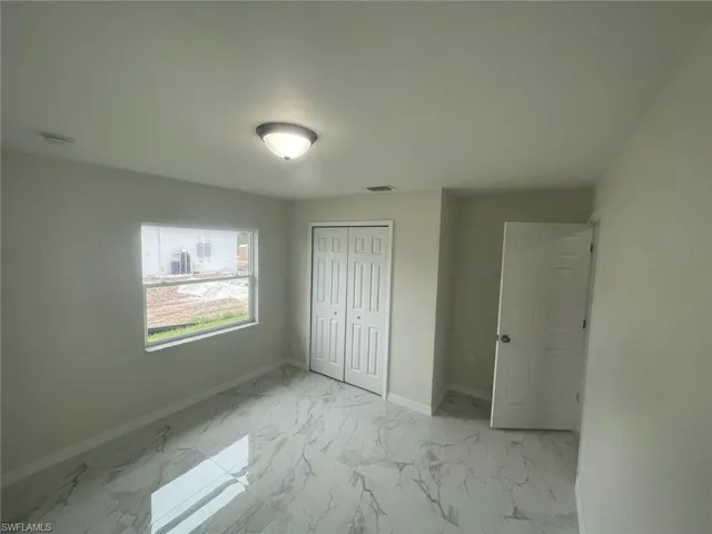 Unfurnished bedroom with a closet