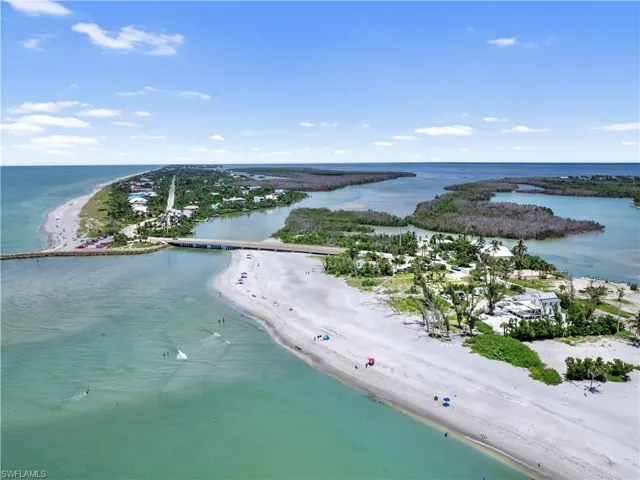 Drone / aerial view with a water view and a view of the beach