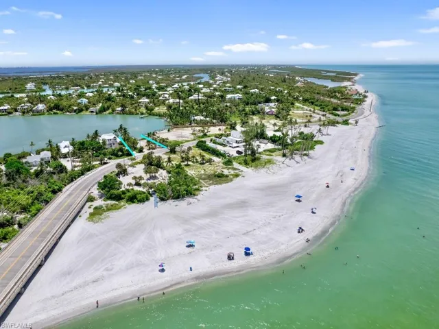 Drone / aerial view with a beach view and a water view