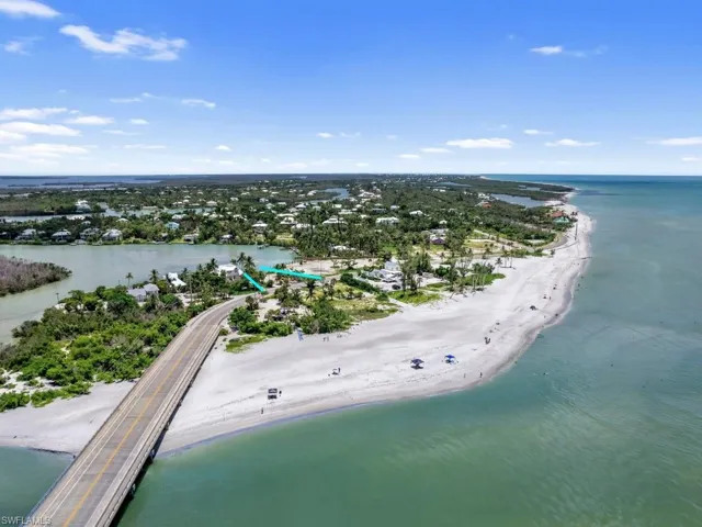 Drone / aerial view featuring a beach view and a water view