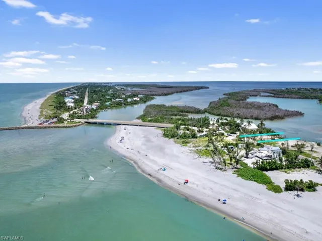 Aerial view with a water view and a view of the beach