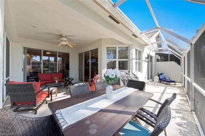 View of patio / terrace with glass enclosure, ceiling fan, and an outdoor living space