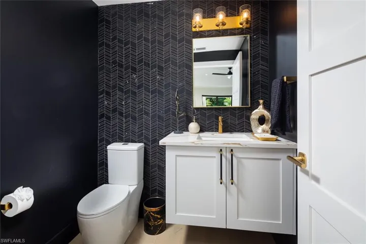 Bathroom with vanity, toilet, and wood-type flooring