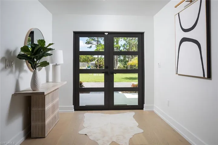 Doorway to outside with french doors and light hardwood floors